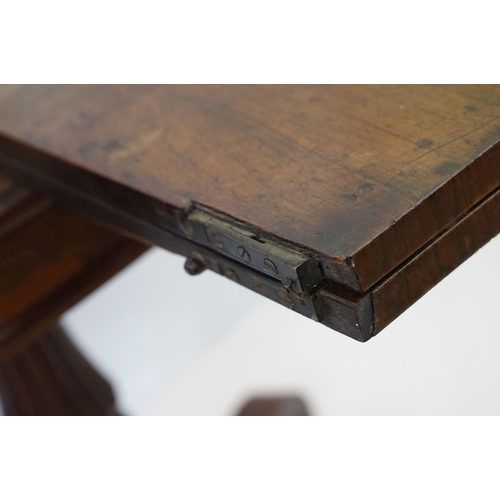 541 - William IV rosewood games table, top swivels to reveal enclosure,  on turned fluted support and four... 