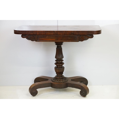 541 - William IV rosewood games table, top swivels to reveal enclosure,  on turned fluted support and four... 