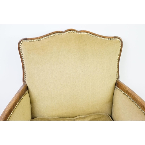 522 - Early 20th century low armchair with oak frame, upholstered in beige with studded edging, on cabriol... 