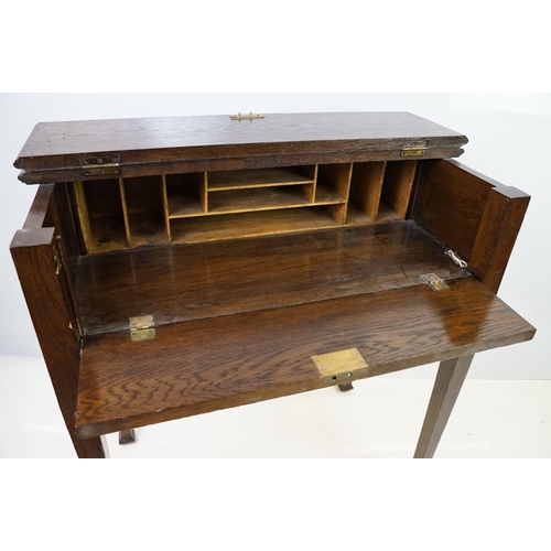 546 - 20th century oak fall front desk, with fitted stationery enclosure, on square tapering legs, with ke... 