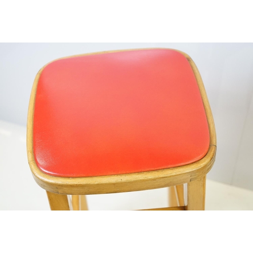 547 - Pair of vintage kitchen high stools, with red leatherette padded seats, each 72.5cm high x 33cm wide... 