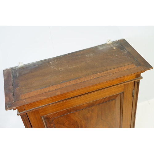 555 - 20th century mahogany hanging wall cabinet, with panelled door above carved bracket base, the interi... 