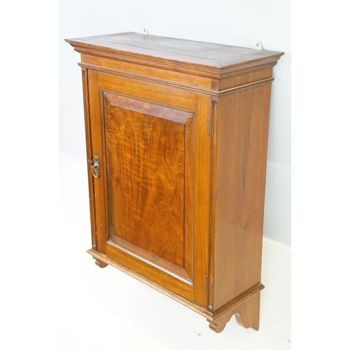 555 - 20th century mahogany hanging wall cabinet, with panelled door above carved bracket base, the interi... 