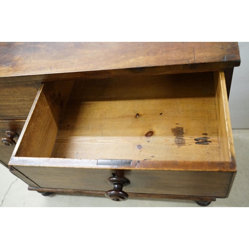 556 - Victorian mahogany chest of two short and three long drawers, with turned handles on turned bun feet... 