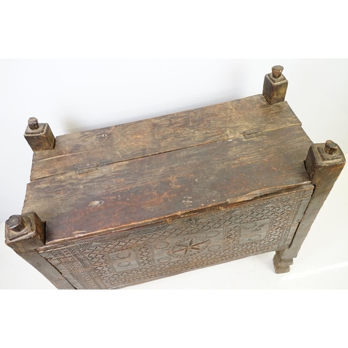 569 - 18th / 19th century Eastern coffer / blanket box, with naively carved panel front and four posts and... 