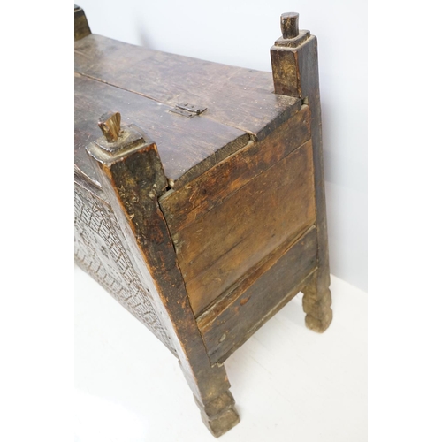 569 - 18th / 19th century Eastern coffer / blanket box, with naively carved panel front and four posts and... 