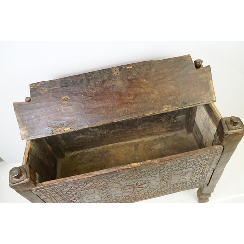 569 - 18th / 19th century Eastern coffer / blanket box, with naively carved panel front and four posts and... 