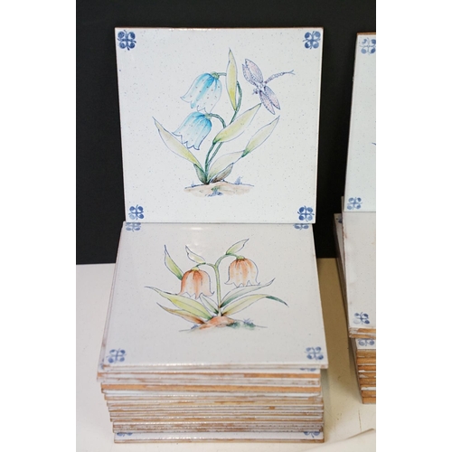 84 - Collection of tin glazed wall tiles each decorated with floral sprays. 4 small boxes.