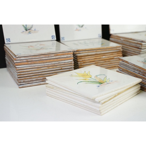 84 - Collection of tin glazed wall tiles each decorated with floral sprays. 4 small boxes.