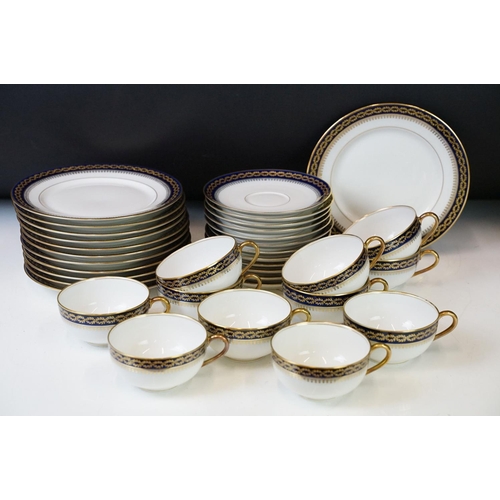 85 - 20th Century vintage Limoges tea service having a white ground with navy blue and gilt rims. Green R... 