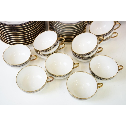 85 - 20th Century vintage Limoges tea service having a white ground with navy blue and gilt rims. Green R... 
