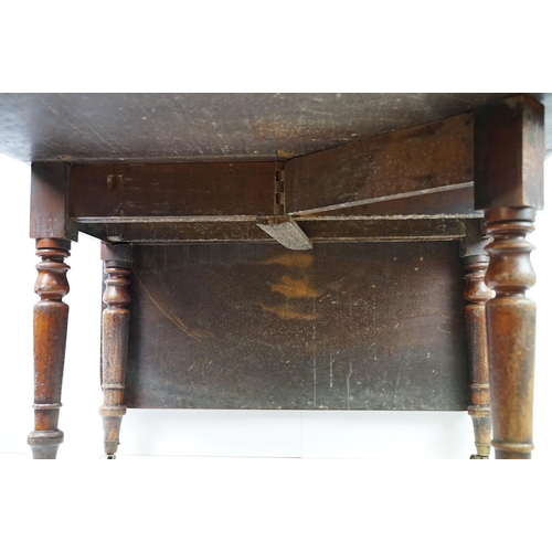 570 - 19th century mahogany drop leaf table, on turned tapering legs with brass casters, 73cm high x 161cm... 