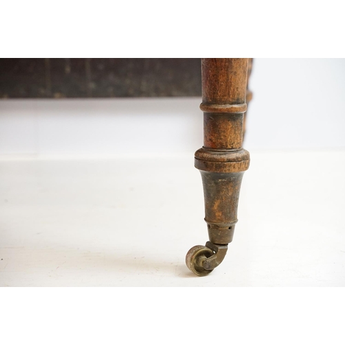 570 - 19th century mahogany drop leaf table, on turned tapering legs with brass casters, 73cm high x 161cm... 