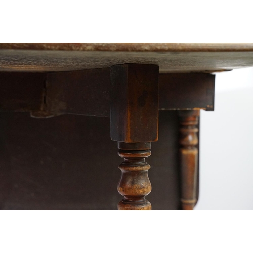 570 - 19th century mahogany drop leaf table, on turned tapering legs with brass casters, 73cm high x 161cm... 