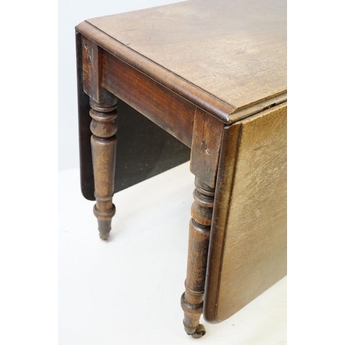 570 - 19th century mahogany drop leaf table, on turned tapering legs with brass casters, 73cm high x 161cm... 