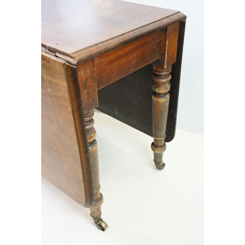 570 - 19th century mahogany drop leaf table, on turned tapering legs with brass casters, 73cm high x 161cm... 