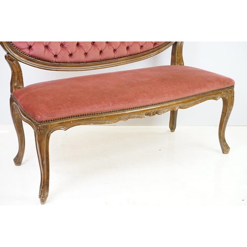 583 - 20th century continental style settee with shaped elaborately pierced back, the button back and seat... 