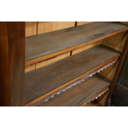 586 - Mahogany bookcase of five shelves, with cut leather gilt embossed fringes, 180cm high x 135cm wide x... 