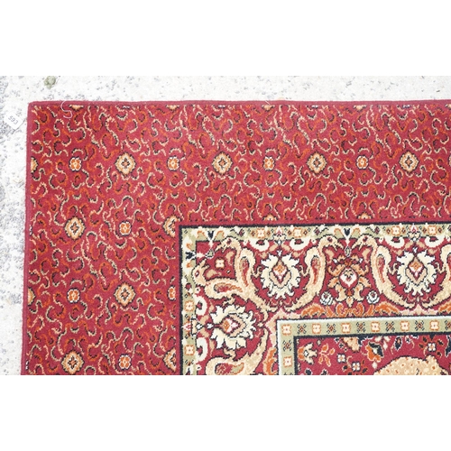 593 - Burgundy ground carpet, the central panel decorated with animals, within a border, 200cm wide x 415c... 