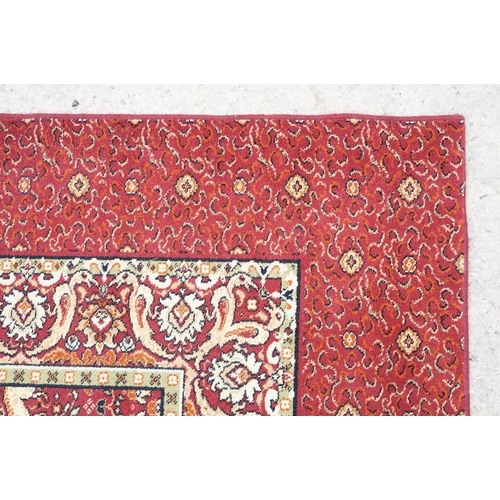 593 - Burgundy ground carpet, the central panel decorated with animals, within a border, 200cm wide x 415c... 