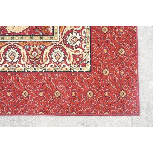 593 - Burgundy ground carpet, the central panel decorated with animals, within a border, 200cm wide x 415c... 