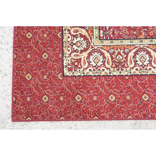 593 - Burgundy ground carpet, the central panel decorated with animals, within a border, 200cm wide x 415c... 