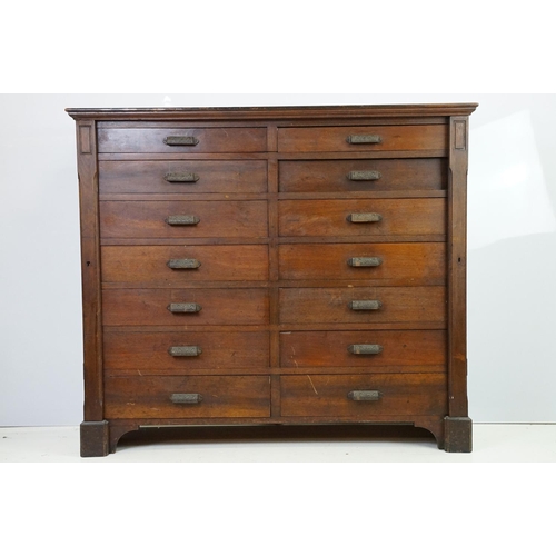 597 - Early 20th century mahogany chest of fourteen drawers, with decorative cast iron handles, with two l... 