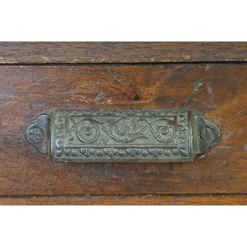 597 - Early 20th century mahogany chest of fourteen drawers, with decorative cast iron handles, with two l... 