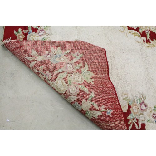 574A - Large red ground wool floor rug with floral decoration, fringe to either end, measures approx 260cm ... 