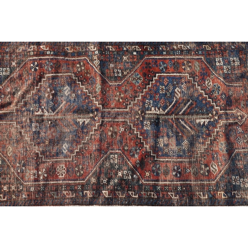 578A - Middle Eastern red ground wool Rug decorated with two guls, 150cm x 118cm