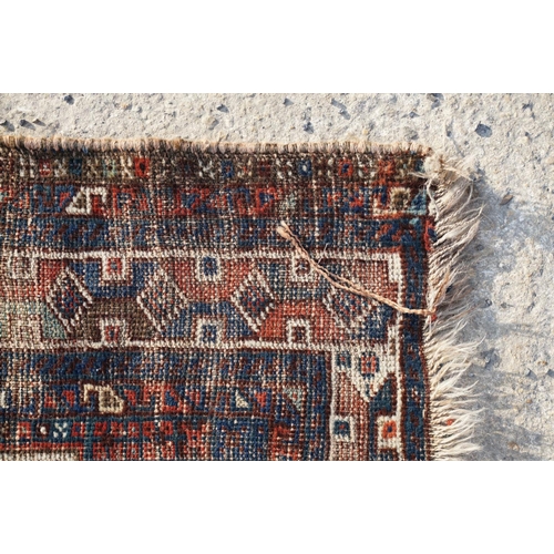 578A - Middle Eastern red ground wool Rug decorated with two guls, 150cm x 118cm