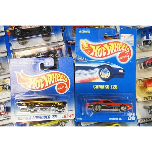 1034 - Around 80 carded Mattel Hot Wheels diecast models, appearing vg and some ex