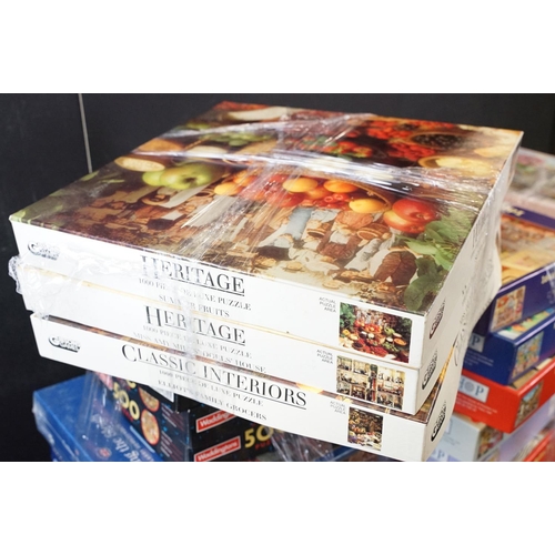 300 - Collection of 100 boxed jigsaw puzzles to include examples from Waddingtons featuring mainly 1000, 1... 