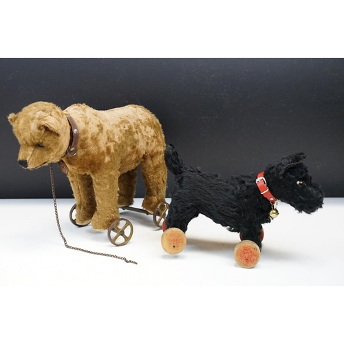 333 - Two Early 20th Century Steiff pull along teddy bears on wheels to include Bear on Wheels, with joint... 