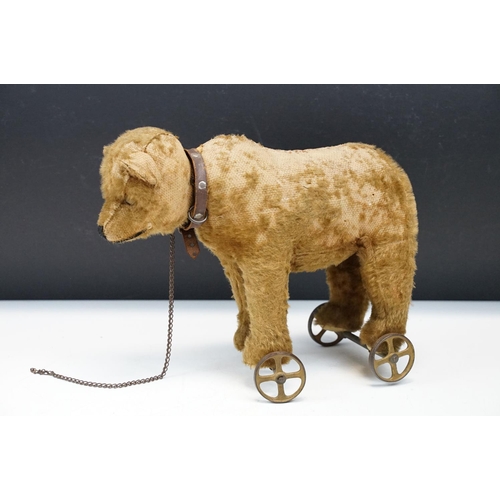 333 - Two Early 20th Century Steiff pull along teddy bears on wheels to include Bear on Wheels, with joint... 