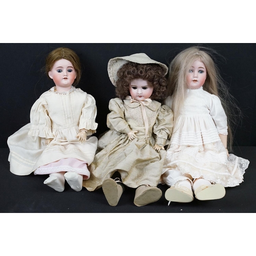 348 - Three Late 19th / early 20th Century bisque headed dolls all having teeth and one with sleeping eyes... 