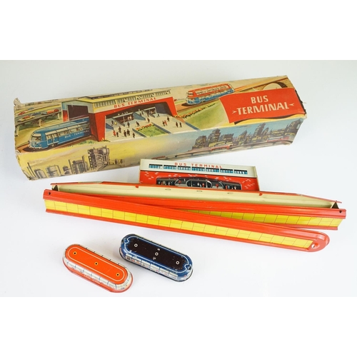 353 - Two boxed tin plate model toys to include Technofix Bus Terminal in original box and missing both en... 