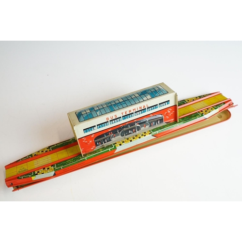 353 - Two boxed tin plate model toys to include Technofix Bus Terminal in original box and missing both en... 