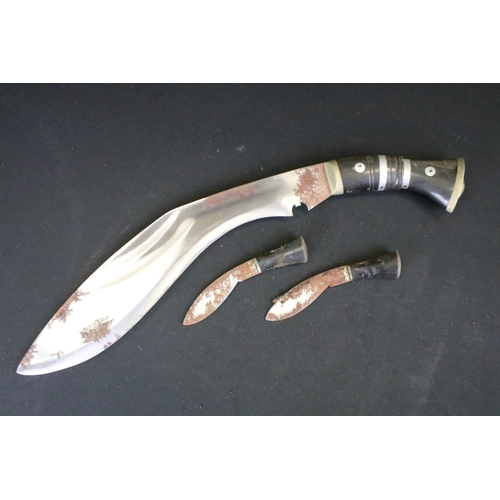 1 - A vintage military supply syndicate Nepalese kukri with leather case. Together with both small knive... 