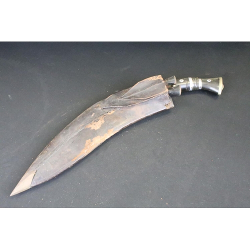 1 - A vintage military supply syndicate Nepalese kukri with leather case. Together with both small knive... 