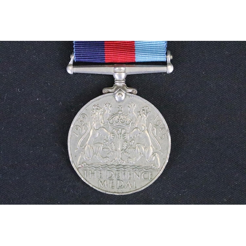 4 - A British full size World War Two medal group to include The 1939-45 British war medal, the Defence ... 