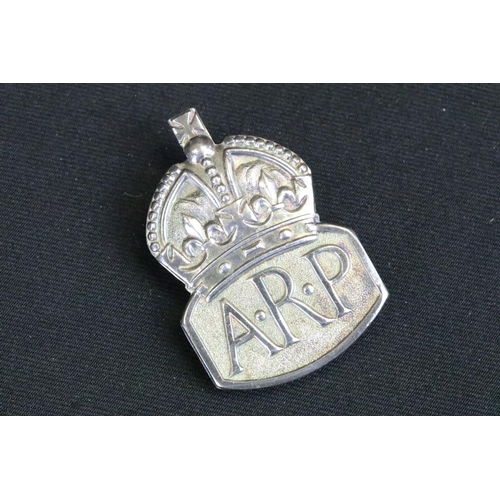 5 - A small group of British World War Two era badges to include silver examples.