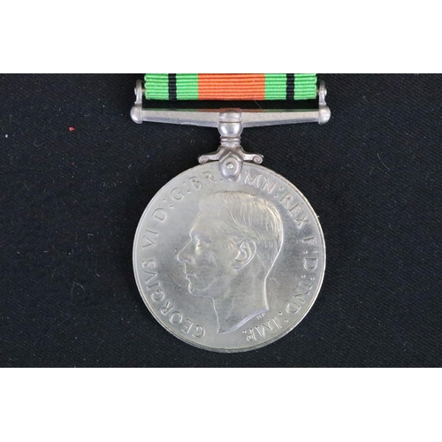 7 - A British full size World War Two medal group to include The 1939-45 British war medal, the Defence ... 