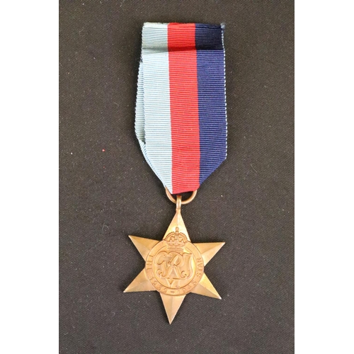 7 - A British full size World War Two medal group to include The 1939-45 British war medal, the Defence ... 