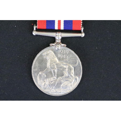 7 - A British full size World War Two medal group to include The 1939-45 British war medal, the Defence ... 