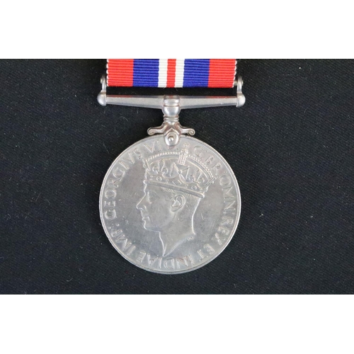 7 - A British full size World War Two medal group to include The 1939-45 British war medal, the Defence ... 