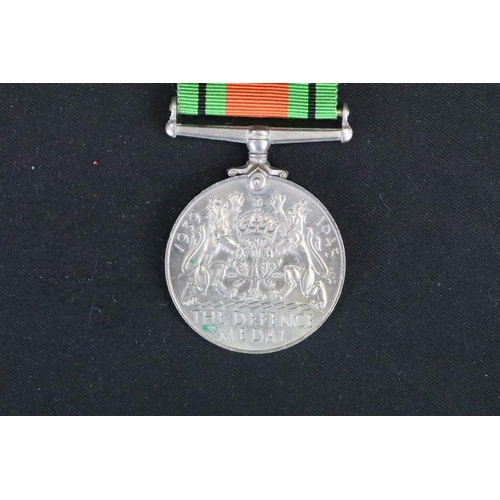 7 - A British full size World War Two medal group to include The 1939-45 British war medal, the Defence ... 