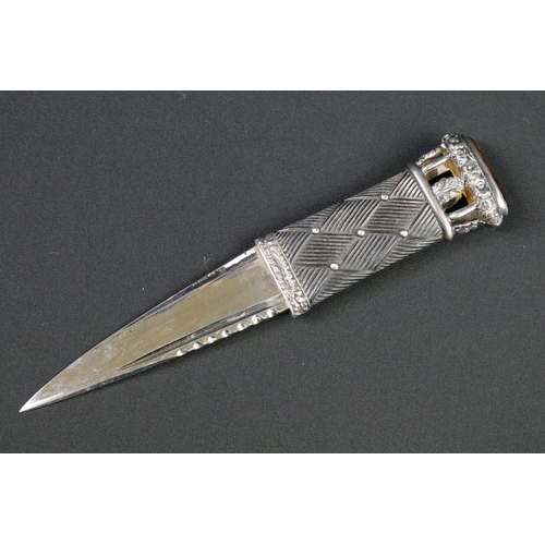 114 - A Scottish dirk dagger with fully hallmarked sterling silver mounts and set with amber coloured ston... 