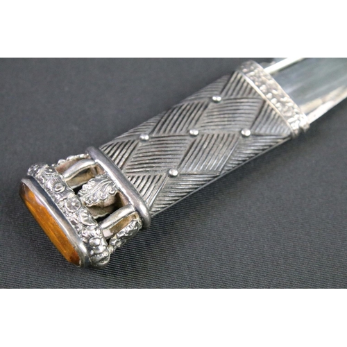 114 - A Scottish dirk dagger with fully hallmarked sterling silver mounts and set with amber coloured ston... 