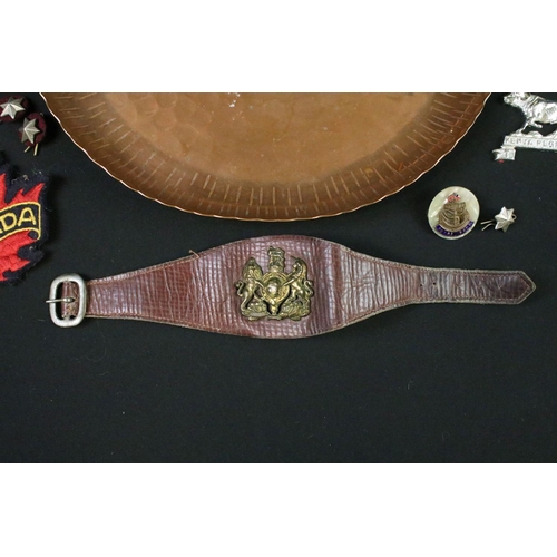 125 - A vintage hammered copper dish badged to the Kenya Regiment together with a quantity of military clo... 